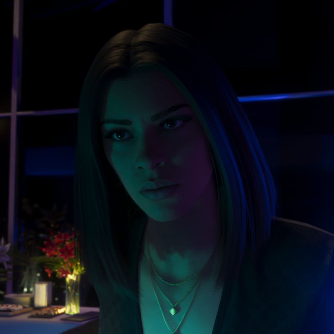 Close portrait of Lucia Caminos with long dark hair under blue and green nighttime lighting.